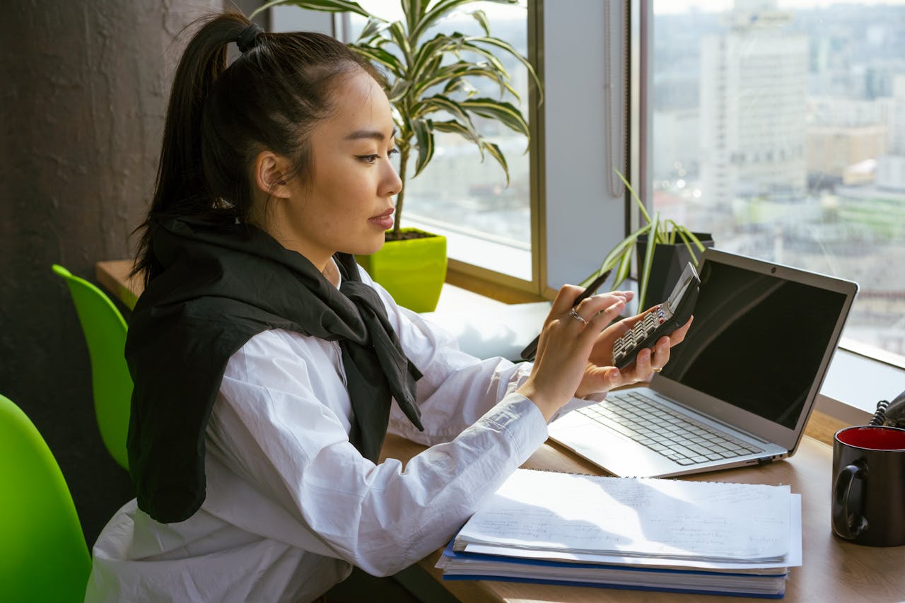 A Woman Computing with a Calculator